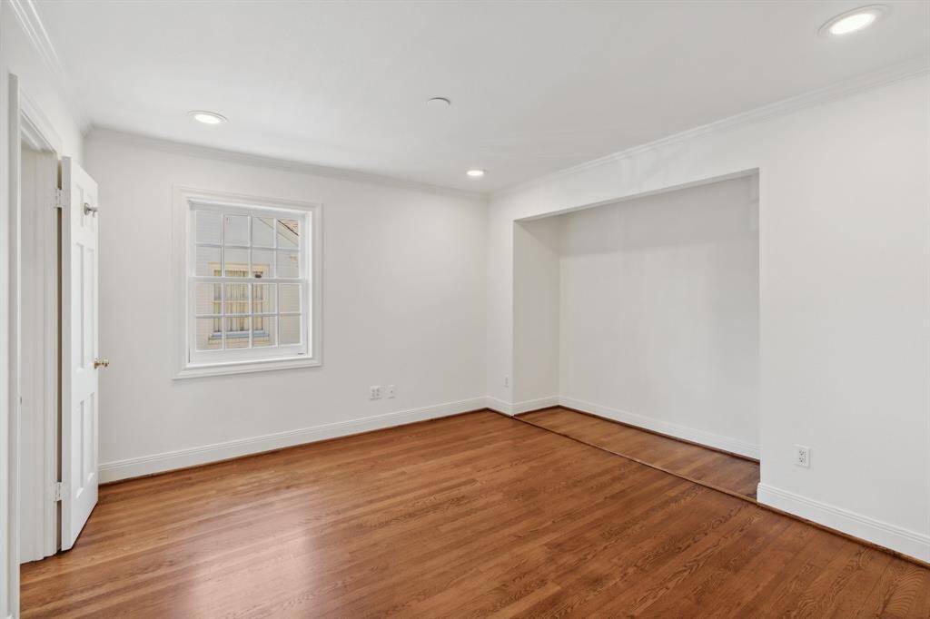 The fourth bedroom [13' x 12'] upstairs was previously used a home office. The recessed wall (upper right in this photo) was the location of the original closet. Choosing to install sliding or acoridian-style closet doors would be a simple  and straighforward do-it-yourself [DIY] project.