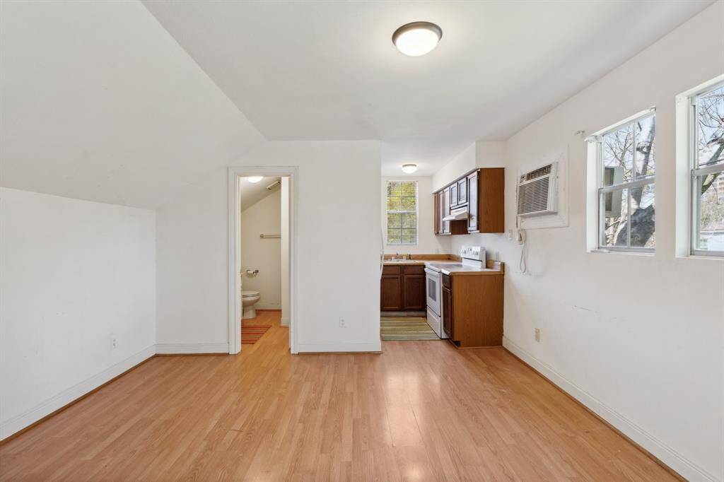 The apartment above the garage is a gem! This space has served the owners well as the fifth bedroom [13' x 12'] and 5th full bathroom option. This practical space, with laminate flooring, includes a kitchen featuring an electric range/oven, vent hood, refrigerator and sink area underneath the western-facing window.
