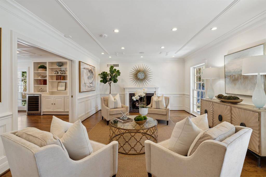 These impressive features stand out within the confines of the living room: floor-to-ceiling windows, tray ceiling, new* LED ceiling lights, plus a handsome mantle and woodburning fireplace. Don't miss the nicely nestled set of pocket doors, which will create a private setting when fully closed. The expansive case opening provides a seamless connection to the library/den.