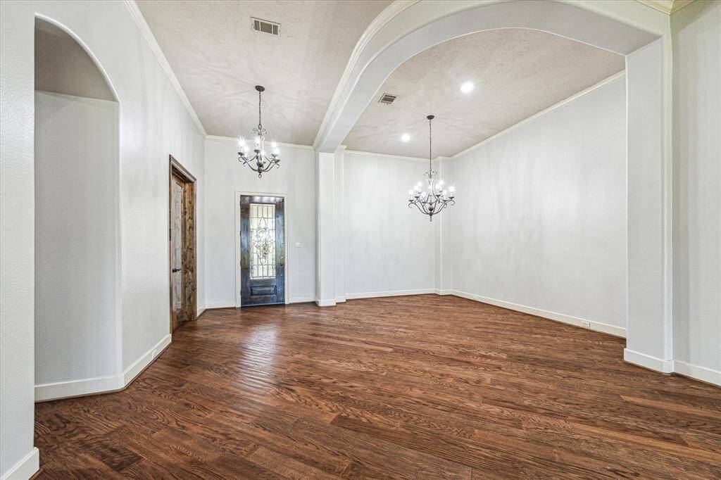Beautiful designer chandelier light fixtures, recessed lights and beautiful hardwood floors are found throughout.