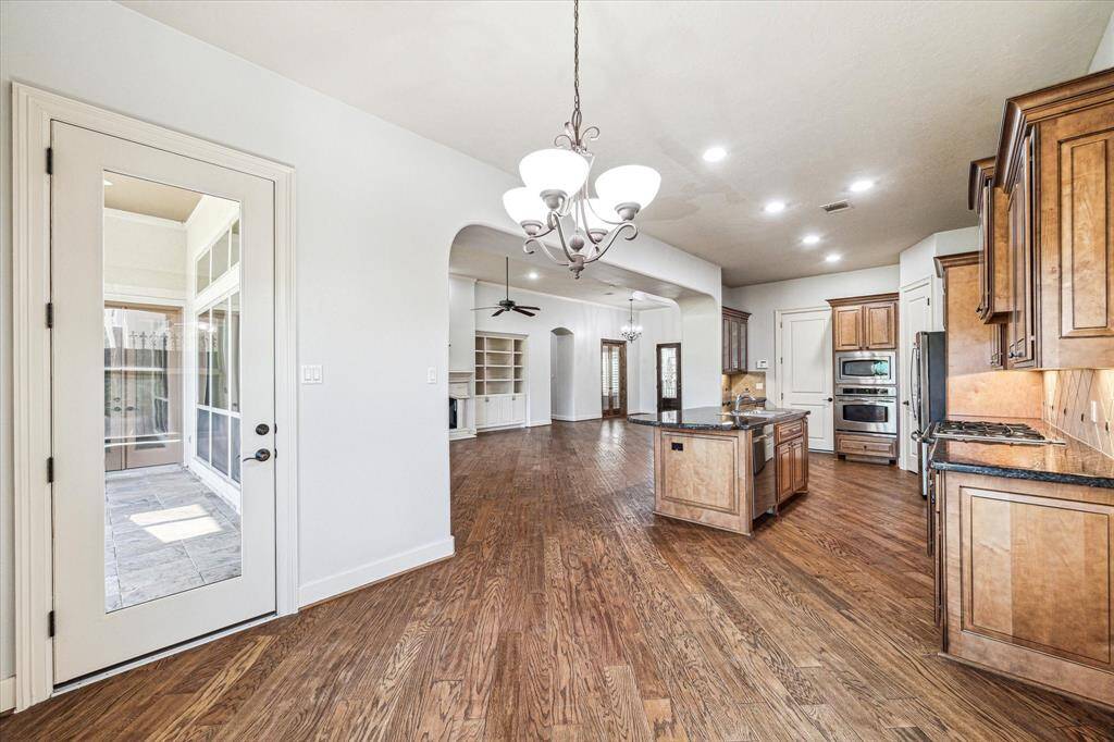 Inviting view from the cozy breakfast room into the spacious kitchen and outdoor patio.