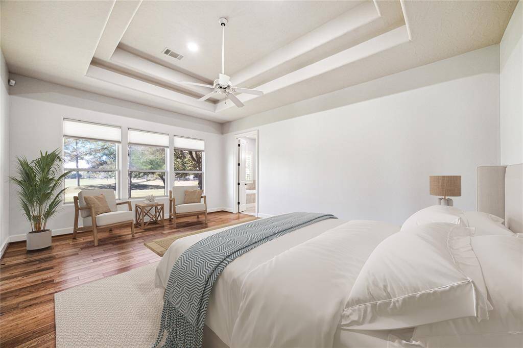 Wake up to incredible golf course views each morning in this grand primary bedroom. Raised ceiling, recessed lights and en-suite bath create privacy and serenity. *Virtually Staged*