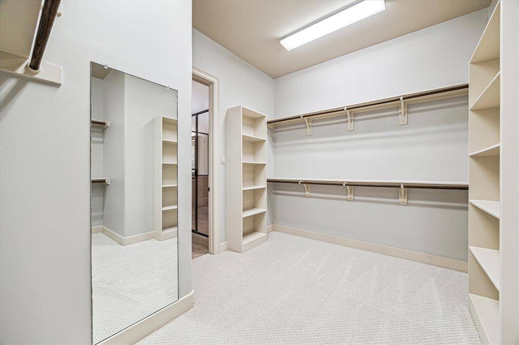 This closet is a dream! Exceptional closet space directly off the primary bathroom has new carpet, incredible storage and ample of clothing racks.