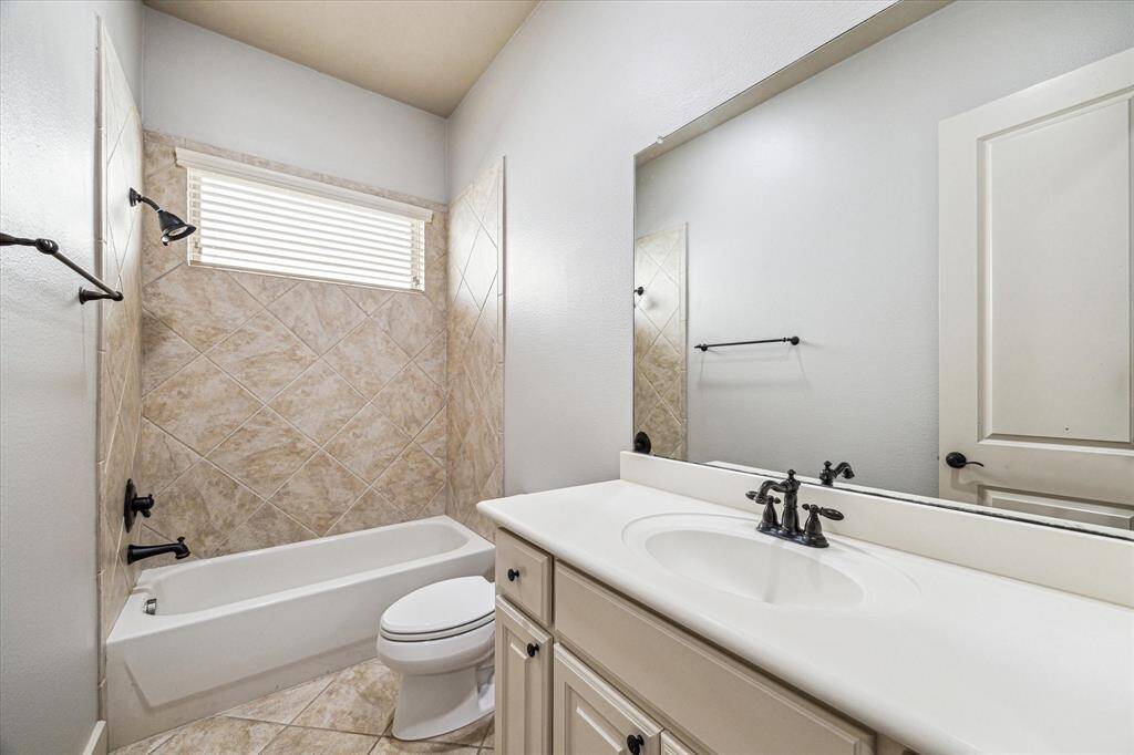 Adjacent to the third bedroom, this secondary bathroom features a convenient full shower and tub combo.