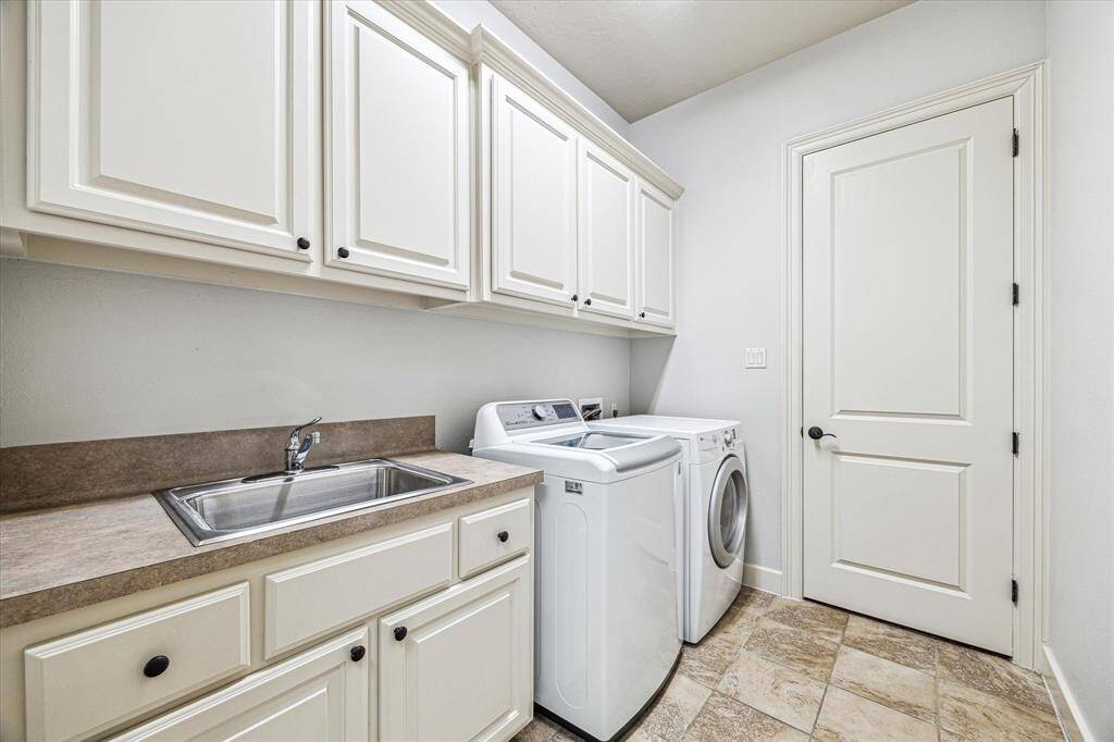 Conveniently connected to the spacious primary closet, the utility room includes a washer and dryer which convey with the home.