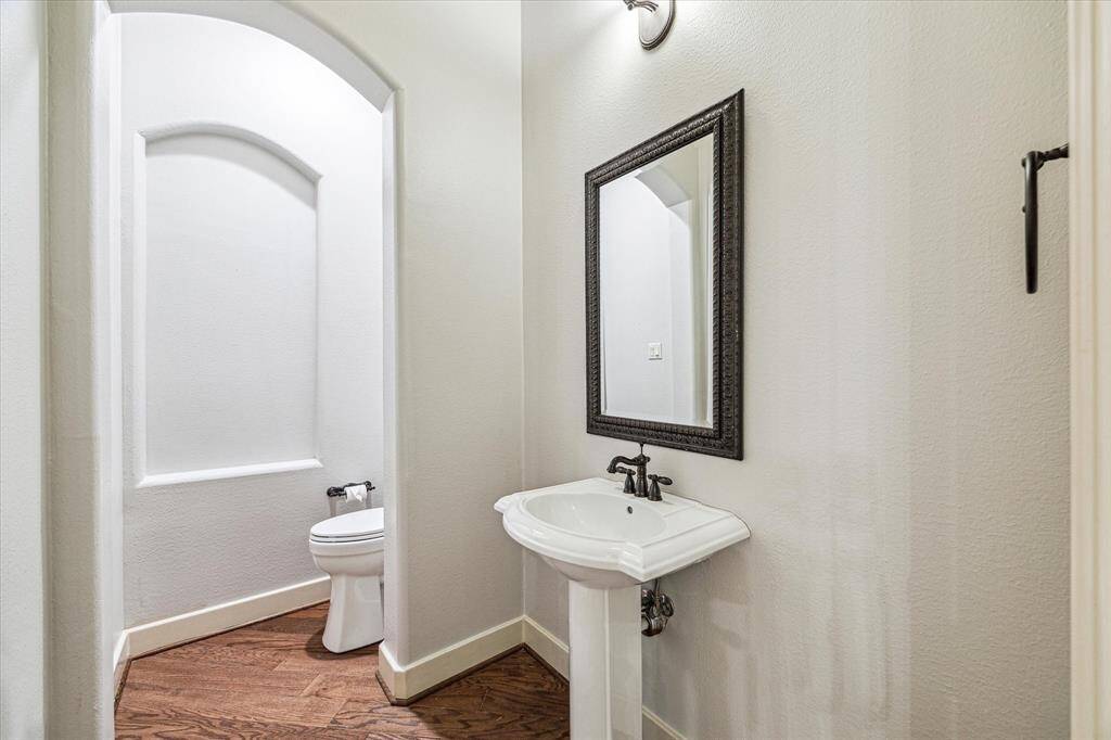 A charming half bath, discreetly located off the family room, features a brand-new toilet.