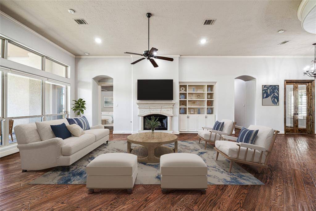 Spacious family room with elegant hardwood floors and abundant natural light. Double glass doors open to the private study, and quaint hallway lead to the primary or secondary bedrooms. *Virtually Staged*