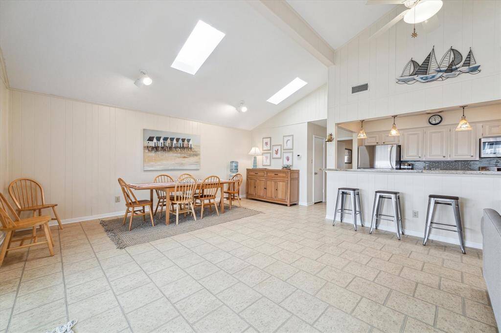 The living dining combo keep everyone together for easy socializing.  And enjoy conversation at the breakfast bar as well - such an inclusive layout!  The door opposite the kitchen is the pantry.