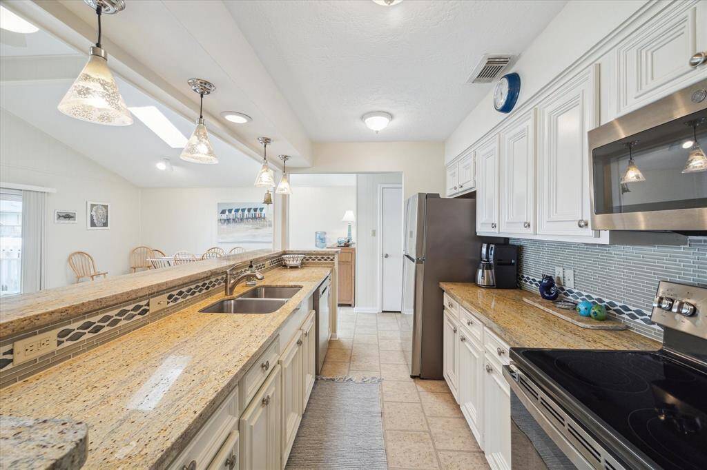 A closer look at the stainless steel appliances and upgraded counters, backsplash and fixtures.