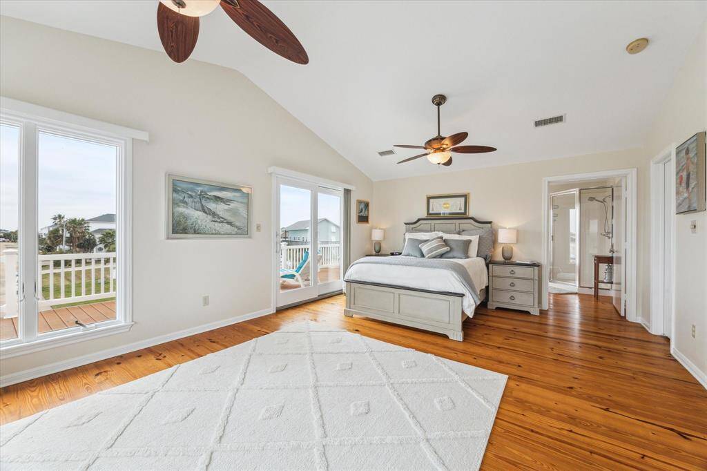 Welcome to the primary suite!  Oversized room with gleaming hardwood floors, walk-in closet, full bath with washer and dryer and a fabulous private deck, perfect for watching the sunset!