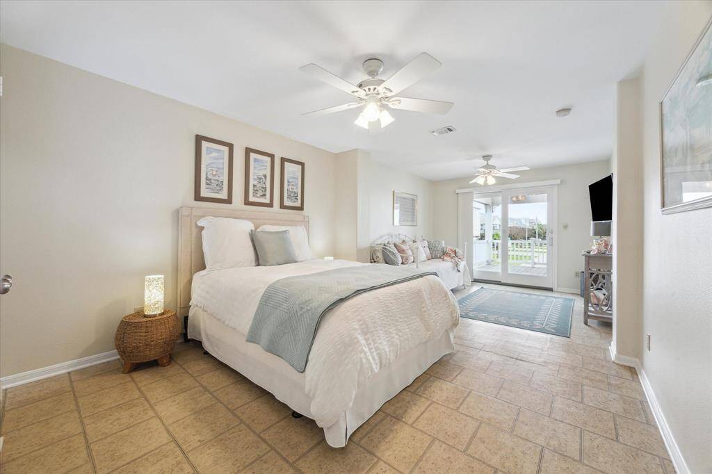 Back on the main floor, this secondary bedroom offers an en suite full bathroom as well as two "sleeping" areas and entrance onto the back deck.