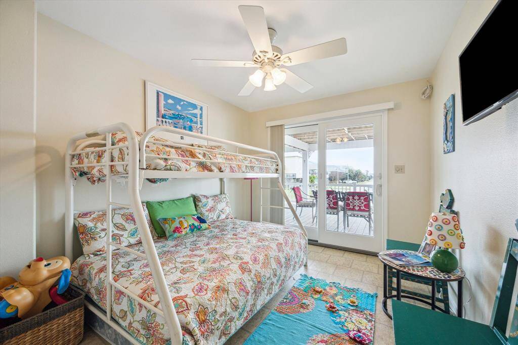The second of the three main floor bedrooms is tucked behind the stairs and also has it's own door to the back deck.