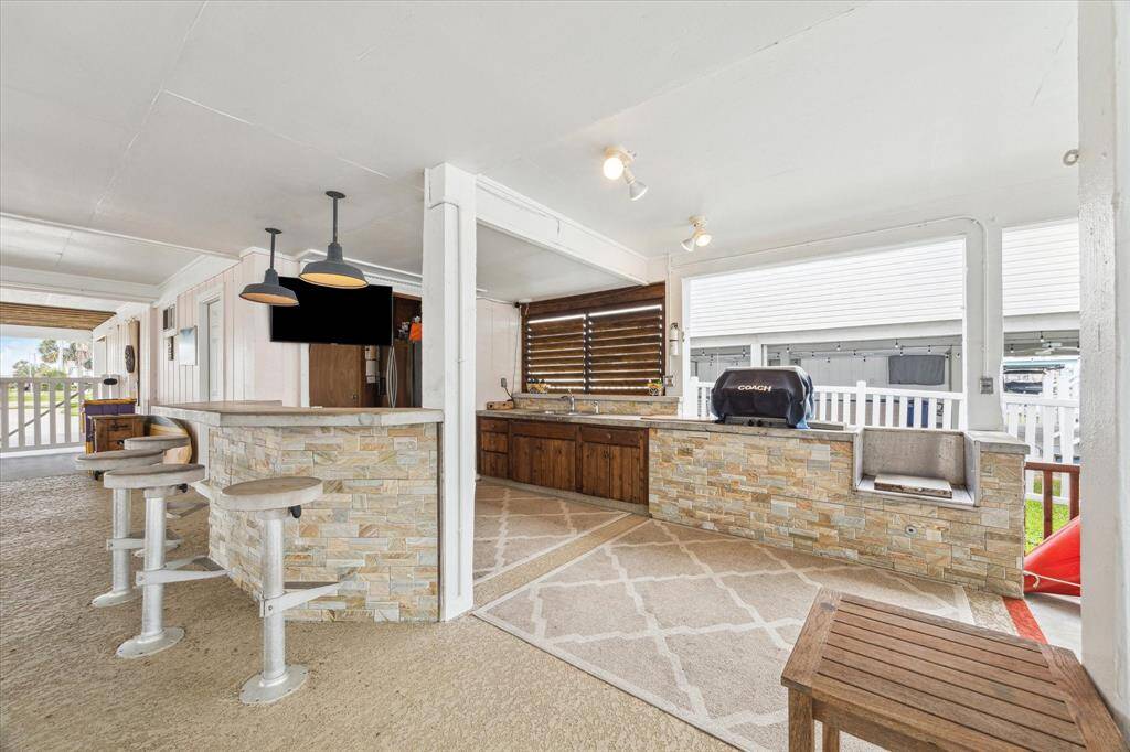 This is where you will spend the most time gathered with family and friends!  This gorgeous outdoor kitchen has it all - including grill, sink, crawfish boiler, side burner, tv for watching your favorite game and more!