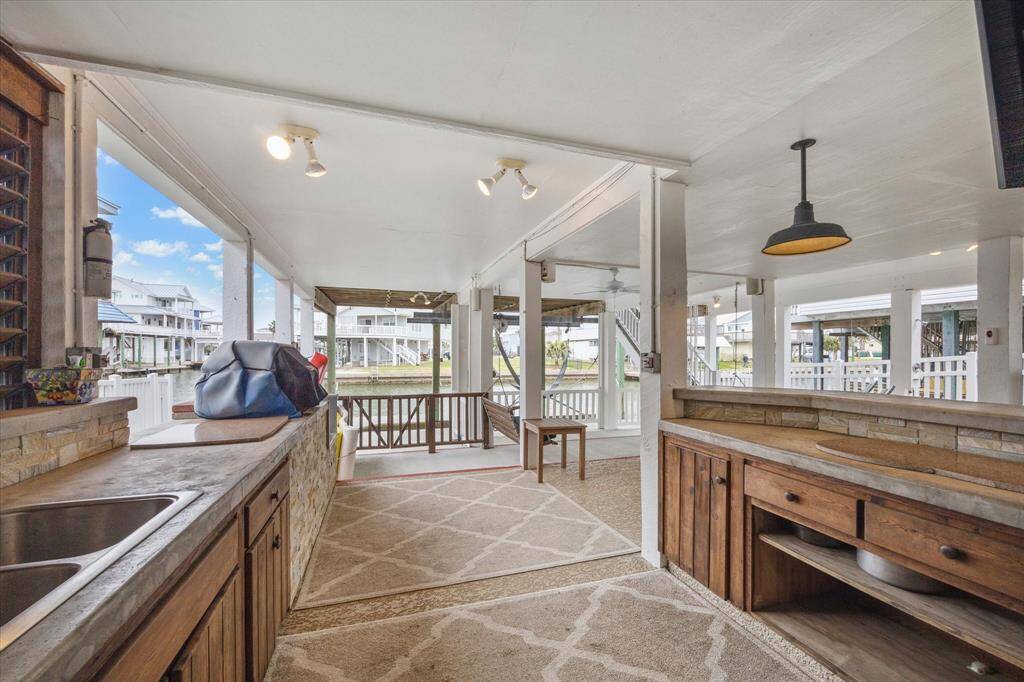 Your grill master sure won't feel left out with this view!  Note the downstairs space is fully fenced for an extra layer of safety for family and pets.