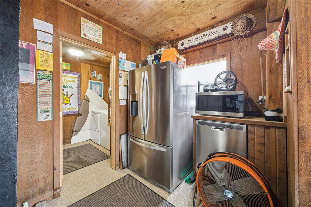 Between the garage and the outdoor kitchen is this utility space that can house extra appliances, a washer and dryer and bathroom.