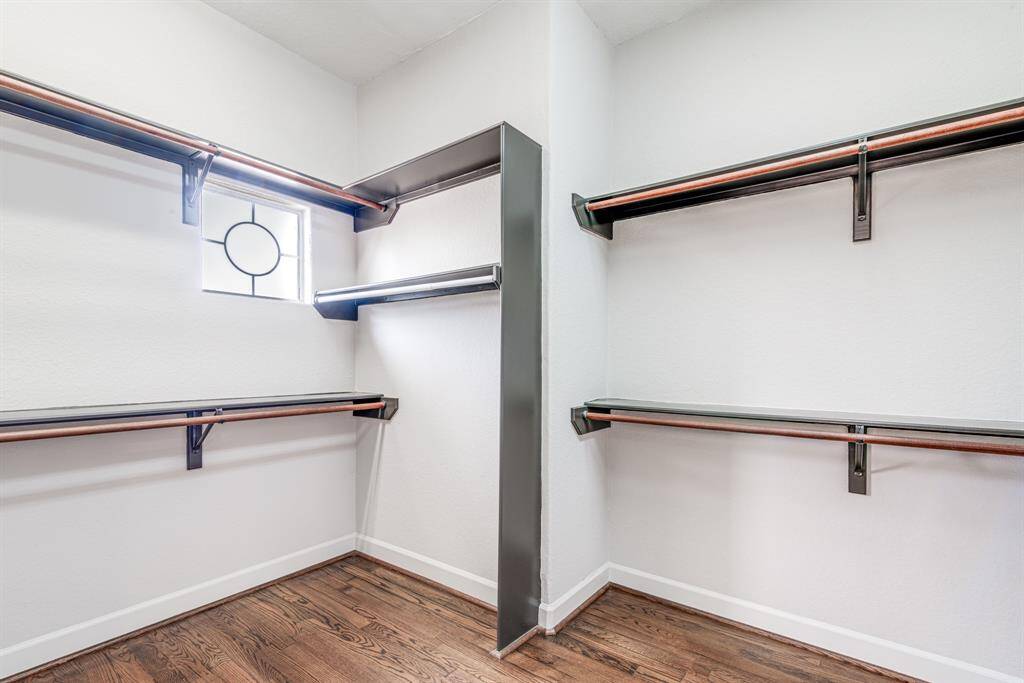 Walk in primary closet with built in organization. So much hanging space.