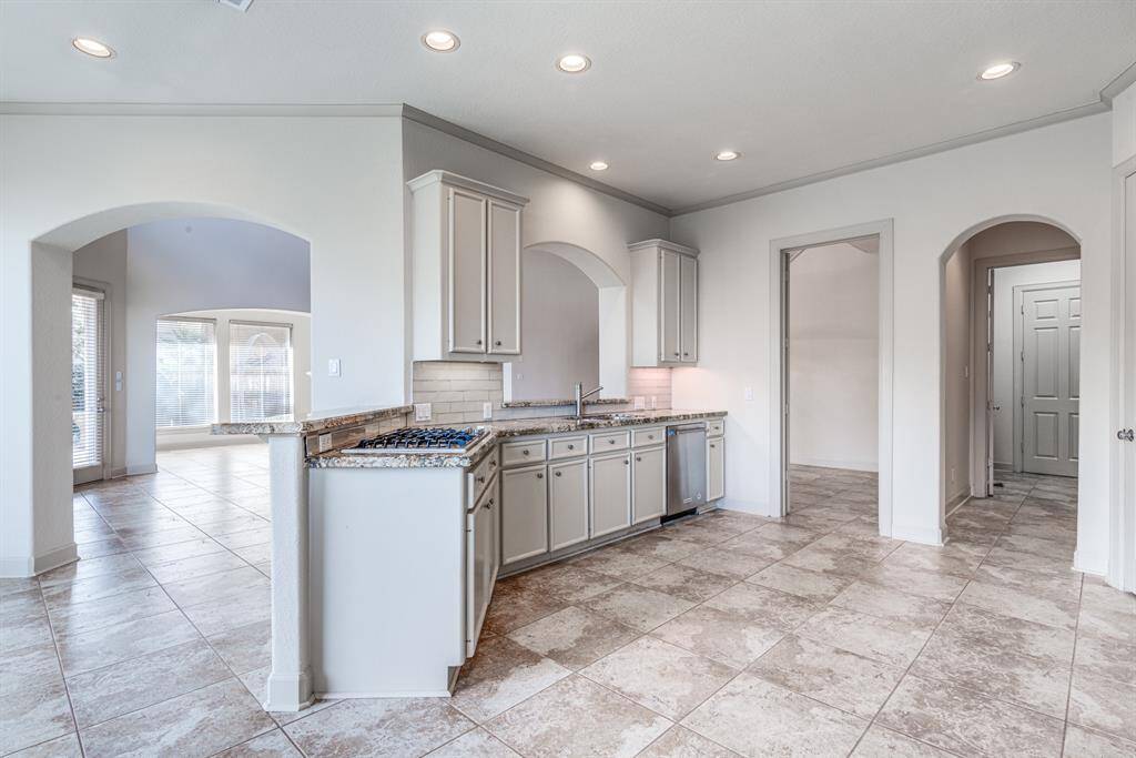 Updated steel appliances throughout including Jenn Air gas cook top. Beautiful tile back splash and granite counter tops. Recessed and under mount lighting and crown molding. This beautiful dream kitchen can be yours!