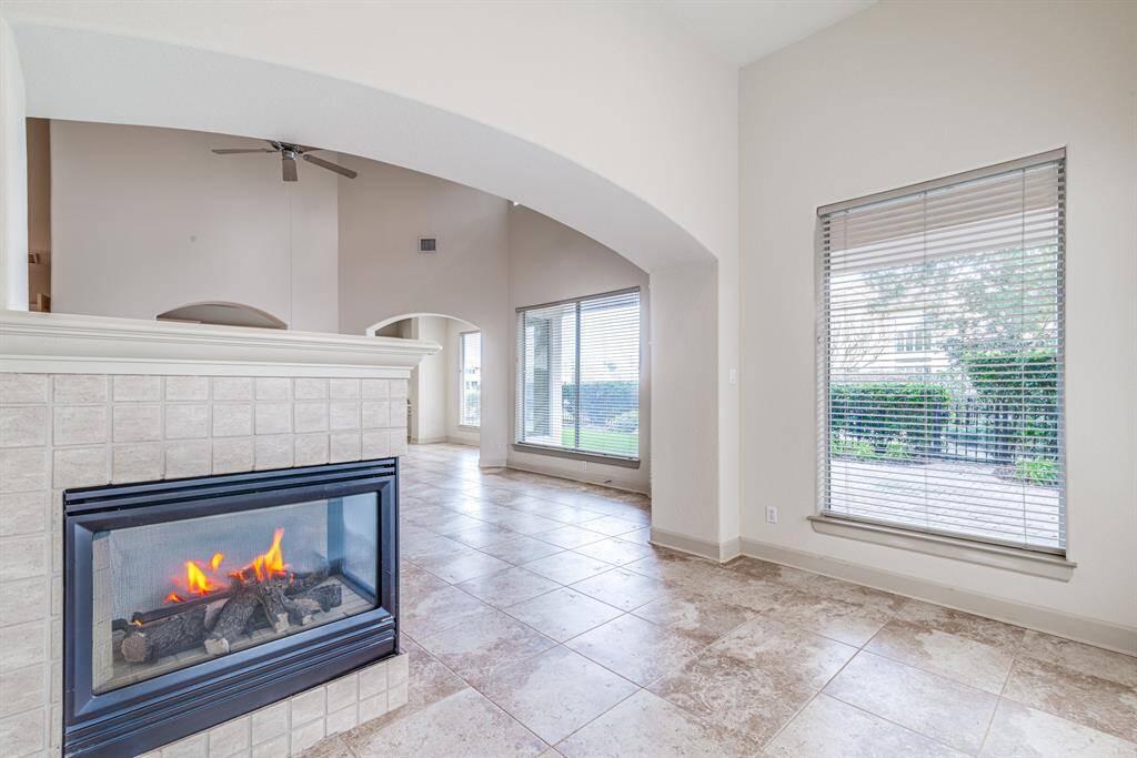 Additional living space with cozy double sided gas log fireplace.