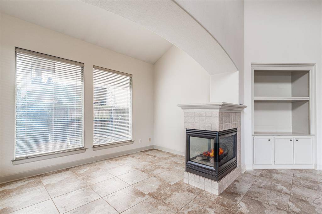 Additional den, living space overlooks the side yard. Notice the built in with storage and beautiful tile floor.
