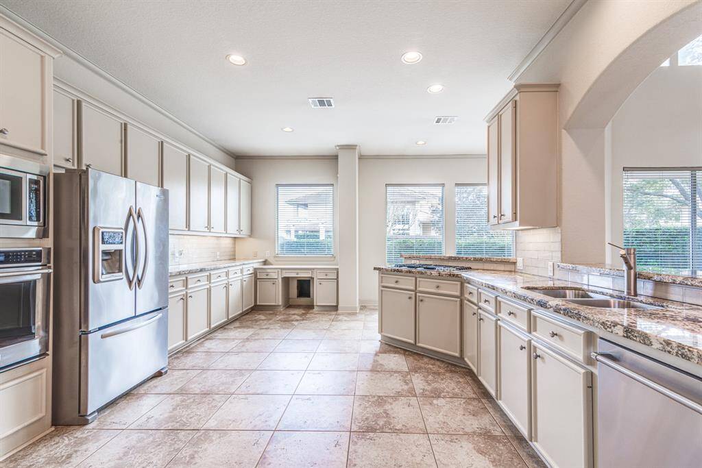 Another fire of this dream kitchen with so much cabinetry. Steel appliances, double sink and two breakfast bars open to living space.
