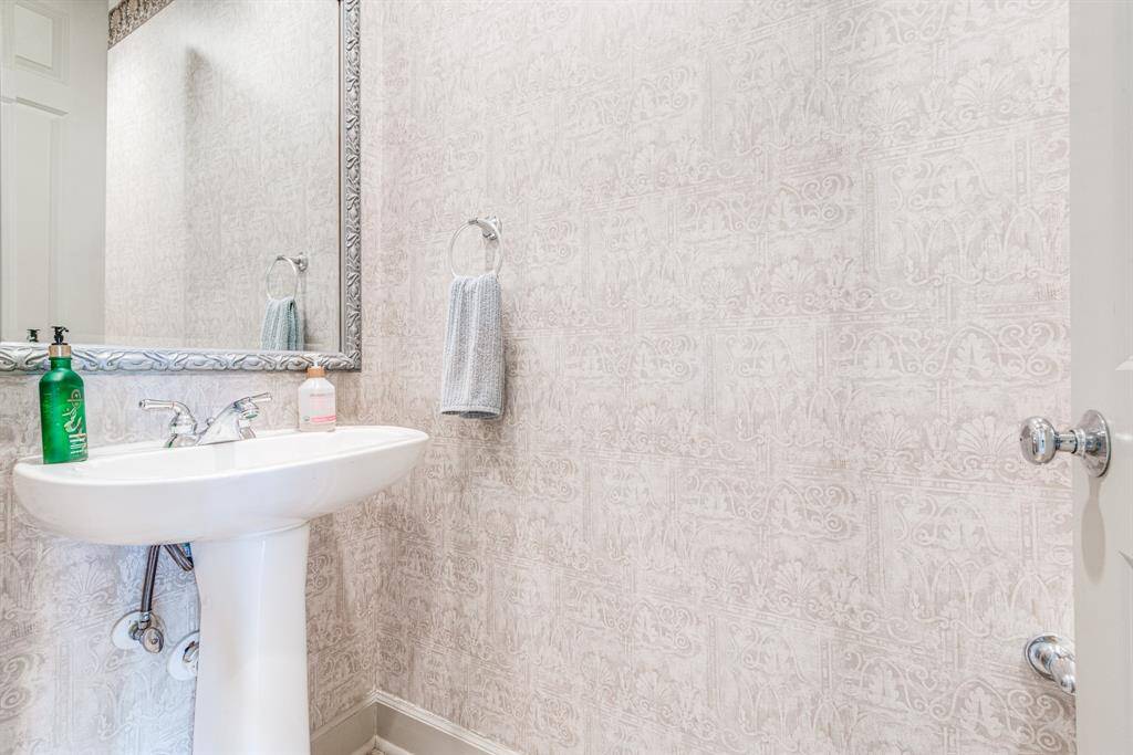 Convenient powder room between garage and kitchen area. Convenient yet tucked away.