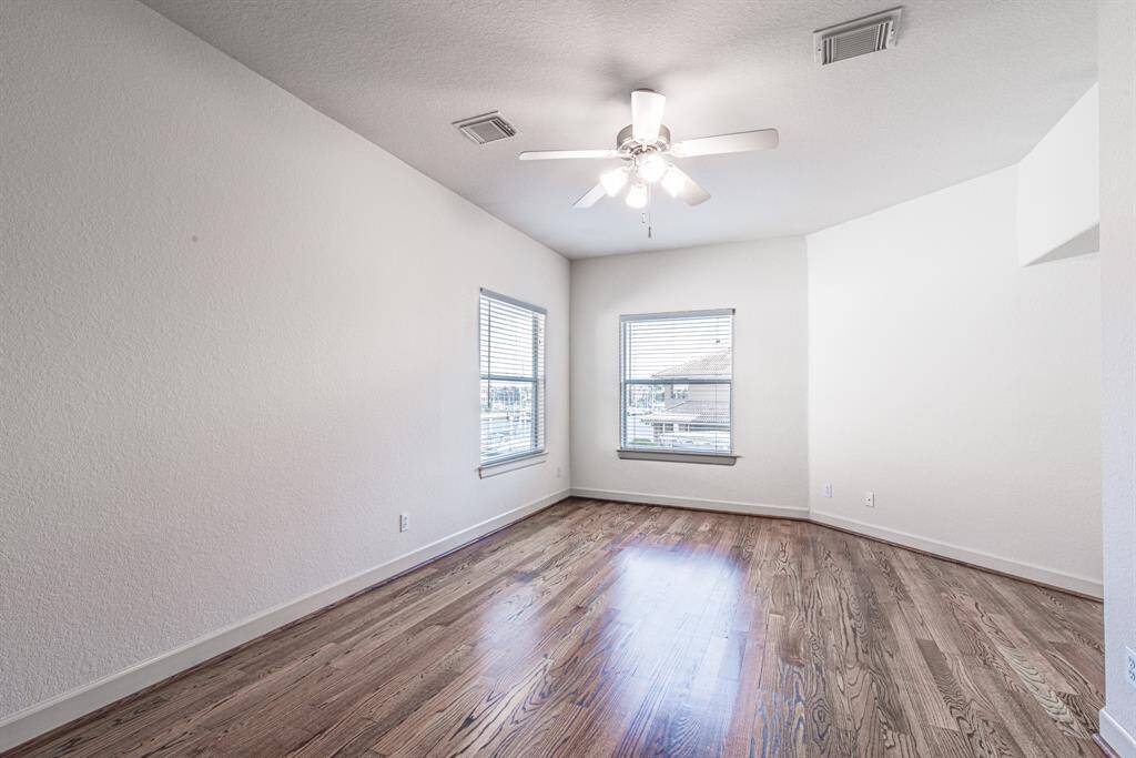 Third bedroom with same stunning wood floor. Enjoy views of the water.