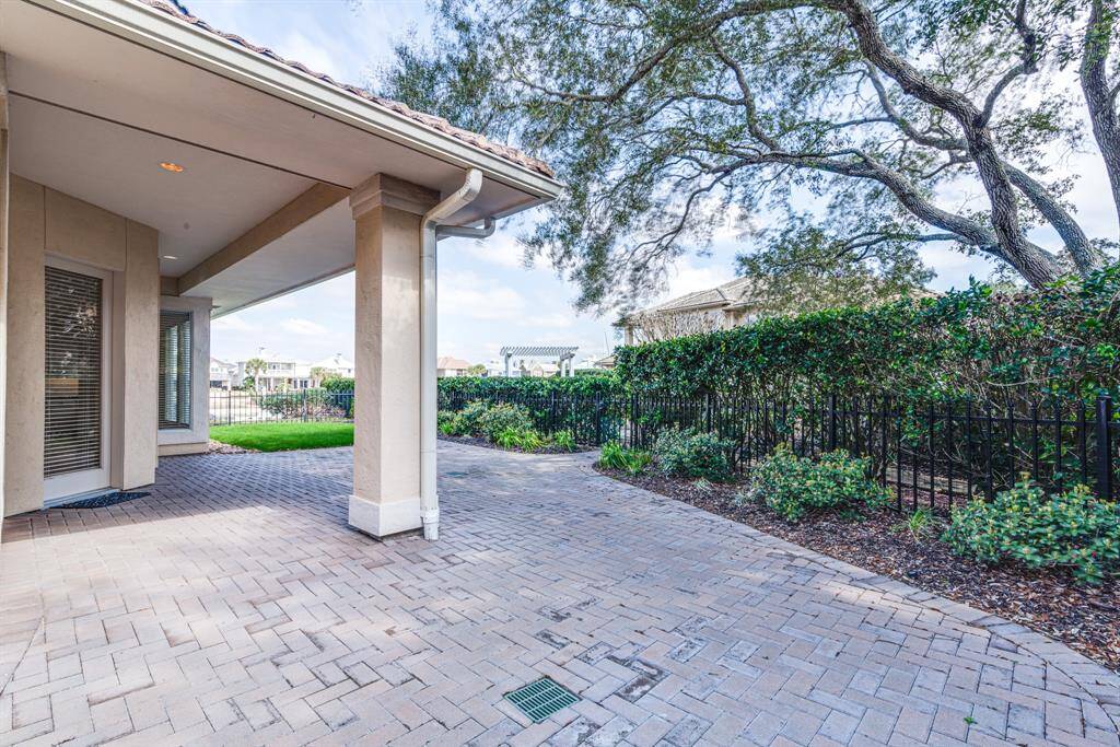 Extended paver patio with covered area and water views.