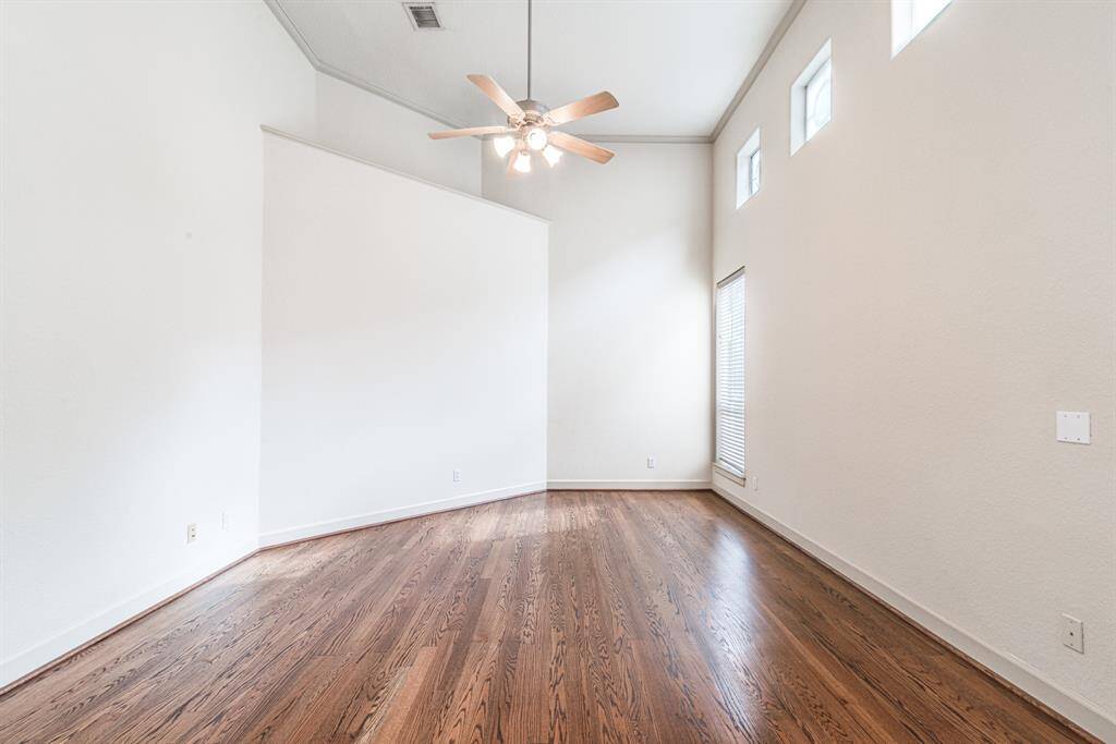 Beautiful wood flooring, crown molding, high ceiling and great light in this primary bedroom.