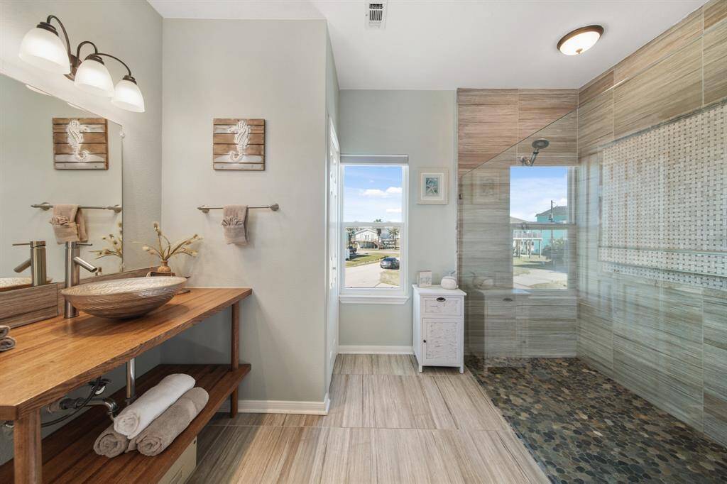 Serene primary bedroom- your private getaway with a spa-like shower, doors to the balcony, and Gulf views to wake up every morning.