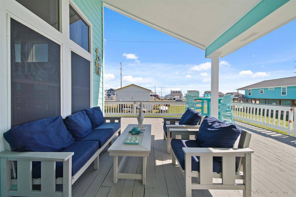 A beautifully designed open concept layout with coastal decor, natural light, and seamless indoor-outdoor views.