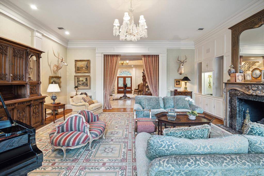 The spacious dining room, featuring a cozy fireplace, is ideal for hosting elegant dinner parties.