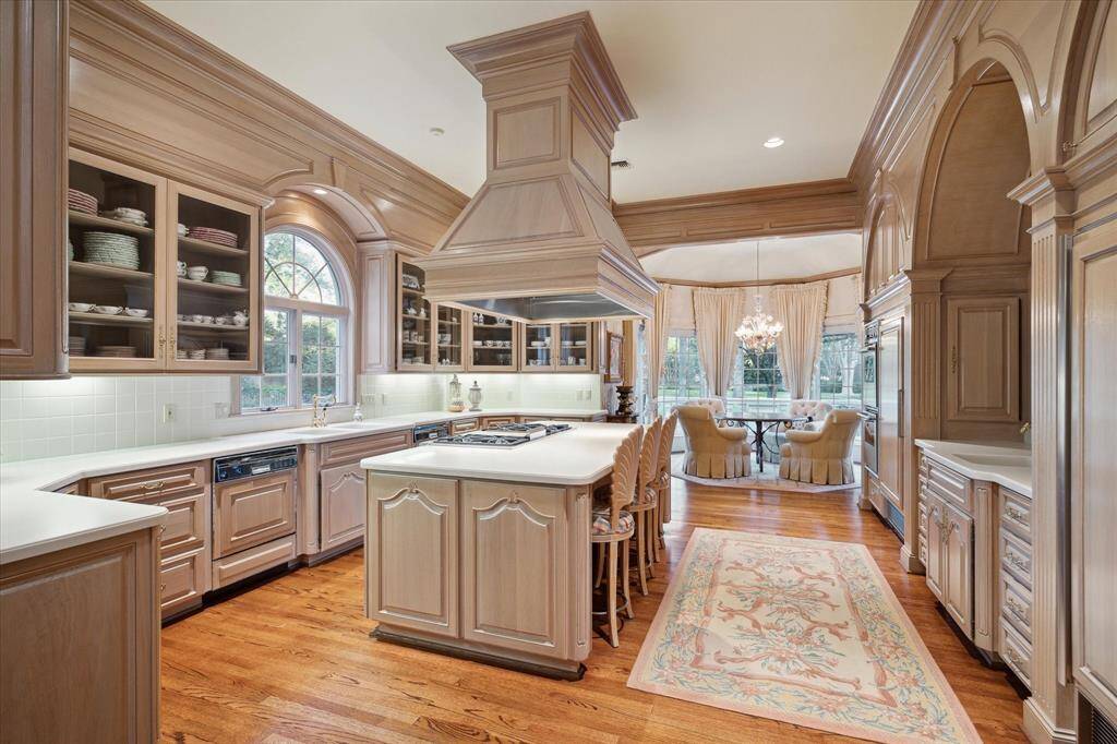 Kitchen with a Sub-Zero refrigerator and freezer, Thermador 6-burner range with griddle, two ovens, and two dishwashers.