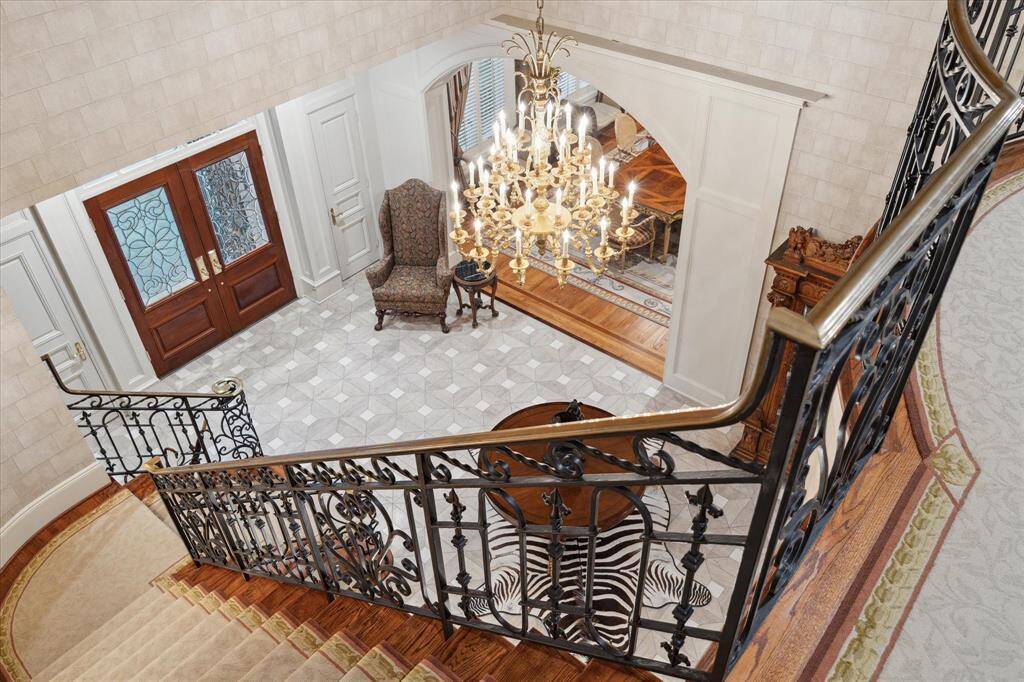 Upstairs family room with double doors and brass hardware, custom medieval knight-themed mural, and built-in play castle/fort.