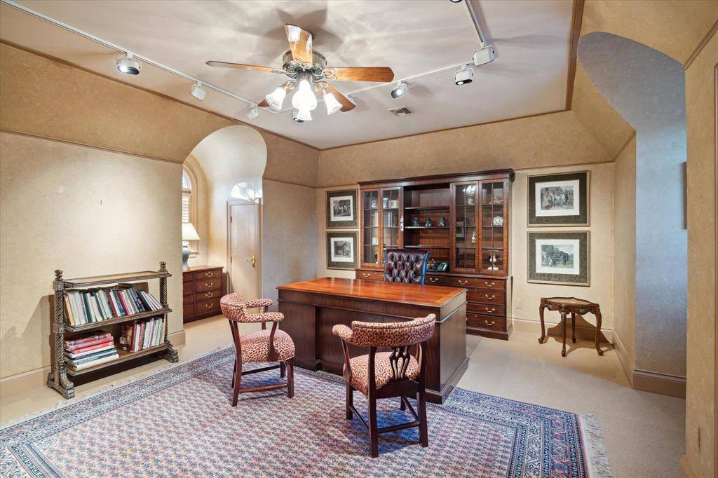 Guest bathroom with ceramic tile floors, Hollywood lighting, frosted glass flush mount light fixture, custom millwork, solid surface counters and sink, brass and porcelain plumbing fixtures and hardware, shower/tub combo, Palladian window, and plantation shutters.
