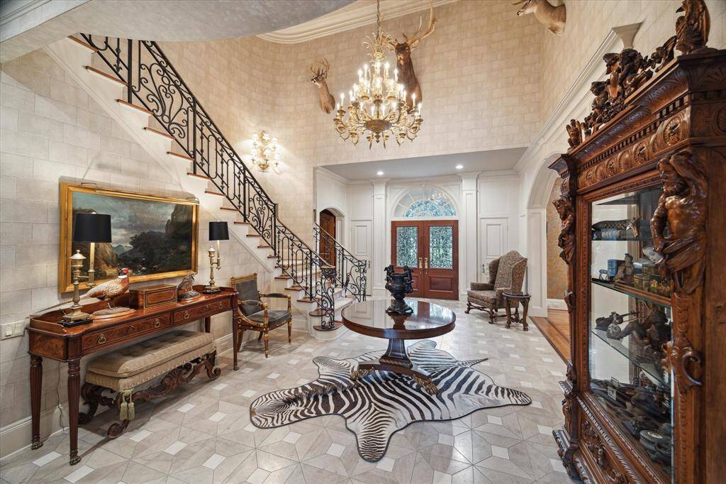 The formal library, with its rich paneled walls and cross-beam ceiling, exudes sophistication and warmth.