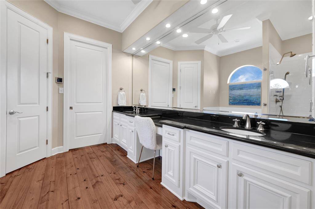 Primary bedroom with large walk in closet with built ins.