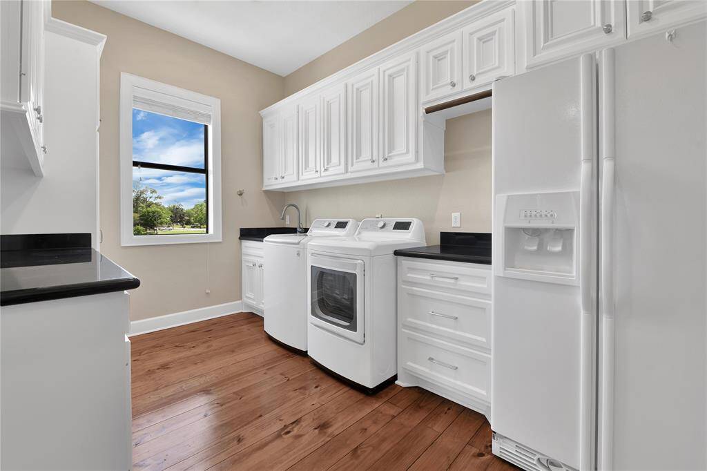 Utility room with second refrigerator.