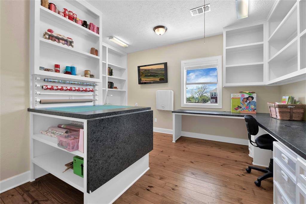 3rd story craft room with built in stations.