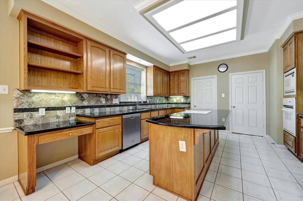 Kitchen with space for multiple cooks and granite countertops.