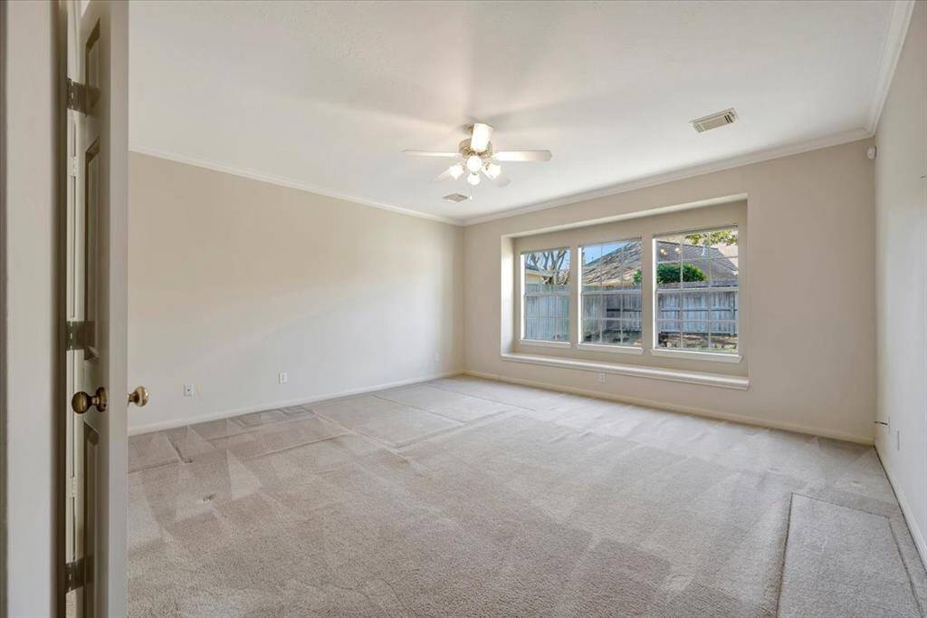 Primary bedroom with view of back yard.