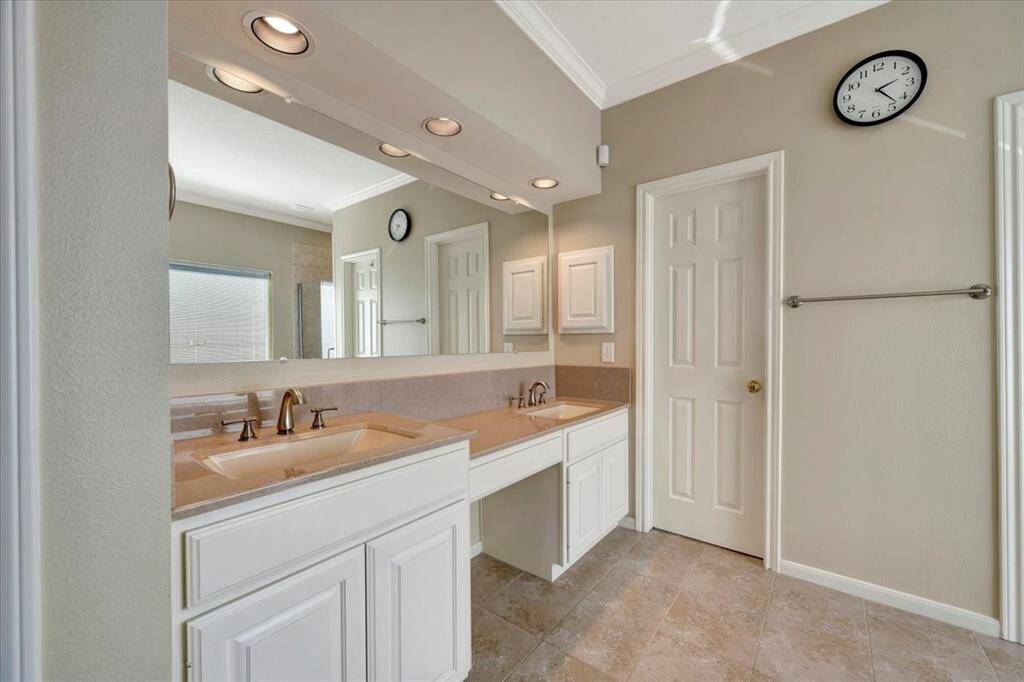 Primary bathroom with updated counters and sinks.