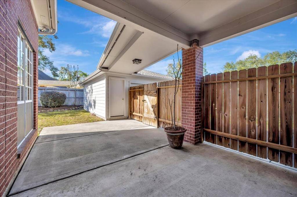 Back patio leading to back yard and two car garage.