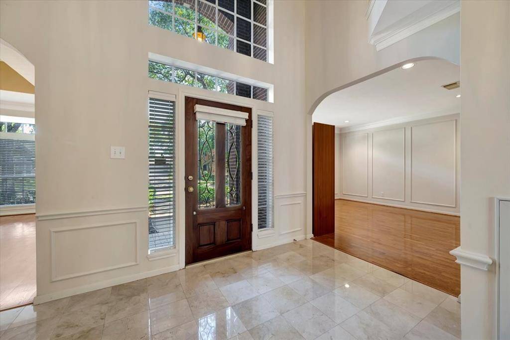 Entry with leaded glass door and looking into study.
