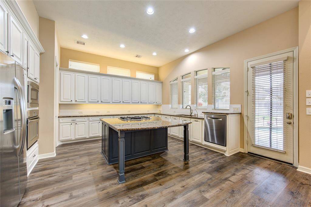 The dark blue island is a great focal point in this beautiful kitchen