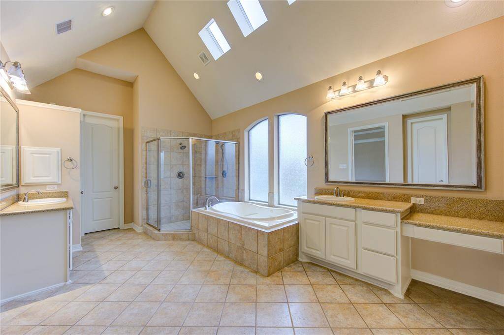 Large primary bathroom, spa tub and 2 vanities.