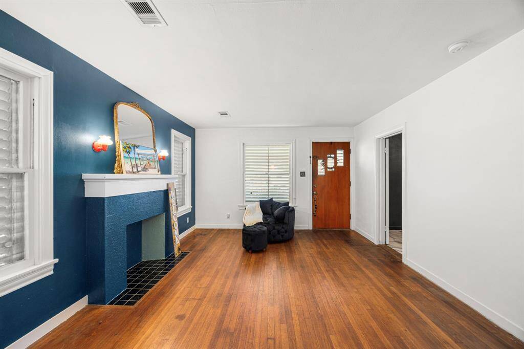 Original hardwoods and mock fireplace add warmth