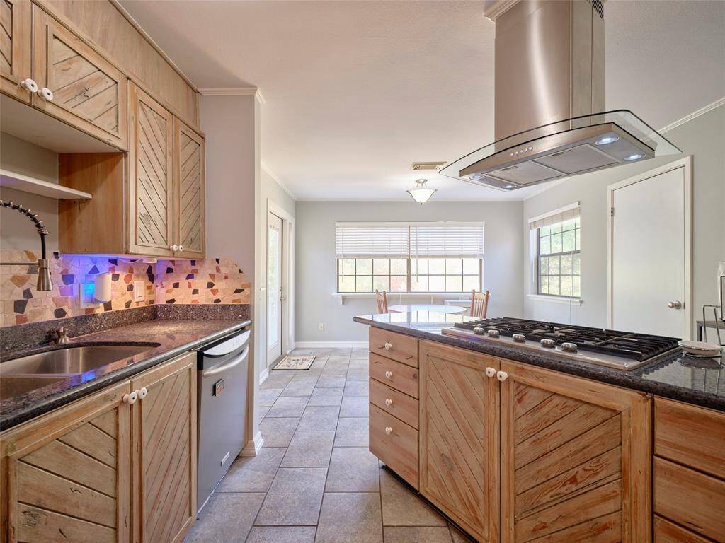 Sleek stainless steel range hood centerpiece.