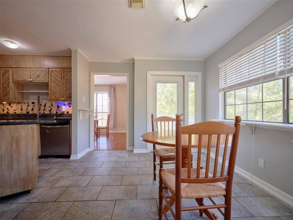 Enjoy your mornings in this cozy breakfast nook with seamless flow to a tranquil patio.