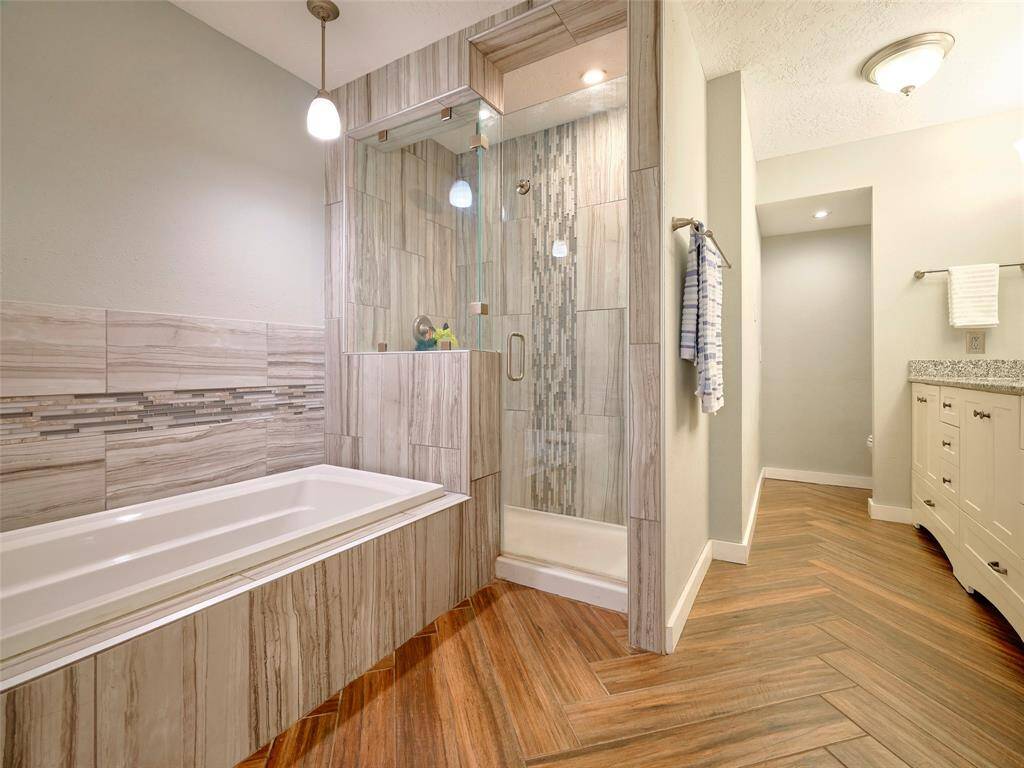 Elegantly renovated primary bath with contemporary finishes.