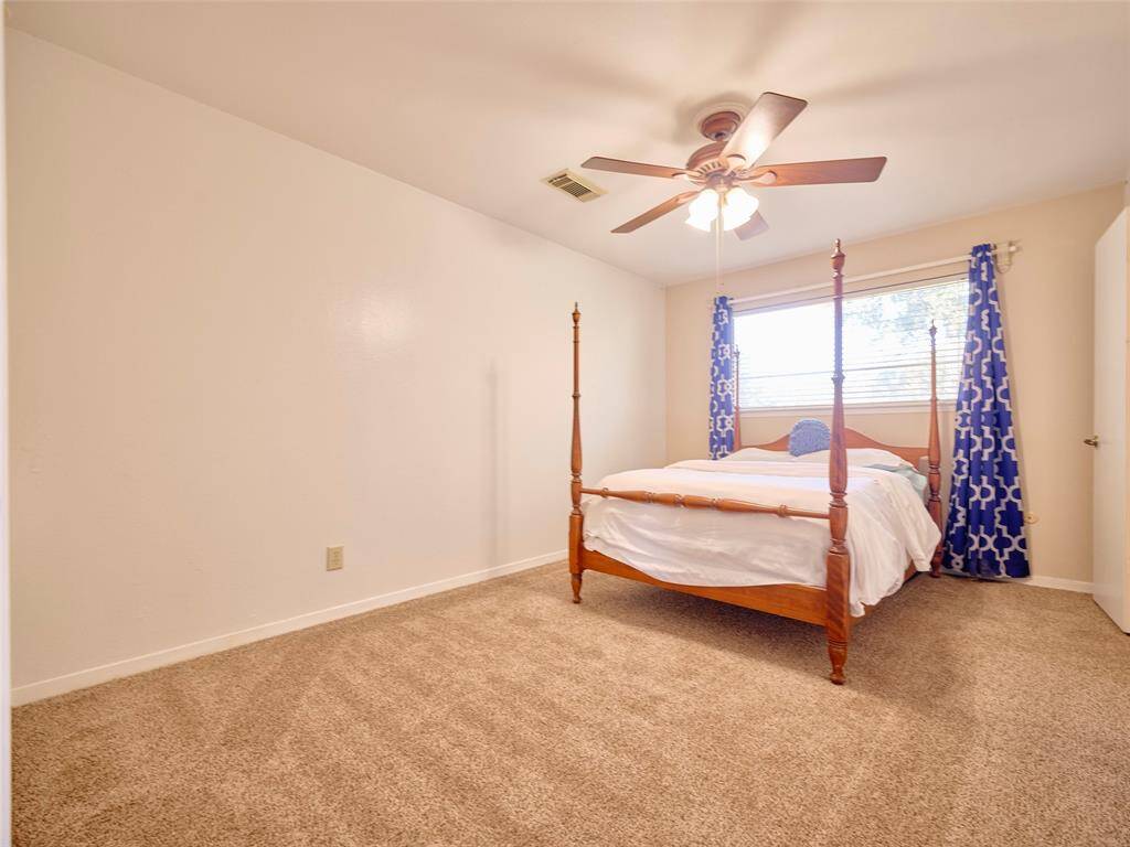 Cozy Secondary Bedroom with Ample Natural Light and Elegant Ceiling Fan